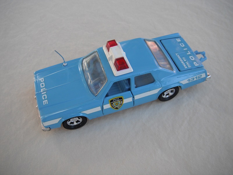 7. Lt. blue body &amp; roof/black England base/lt. blue interior/clear windows/no trim/red dome lights/white frame/NYC Police decals.