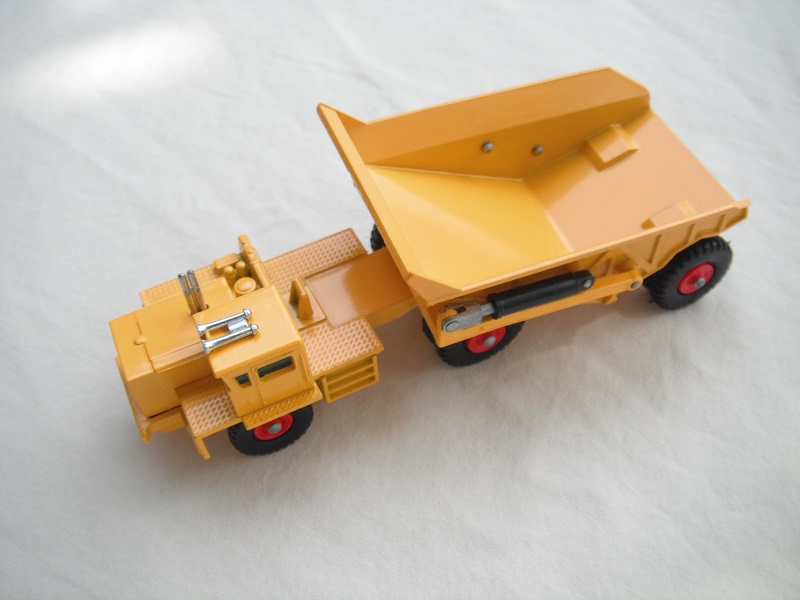 2. Dark yellow body/type 1 base/no rivet braces/ webs on cab's rear axle/green windows/KW-Dart decals.