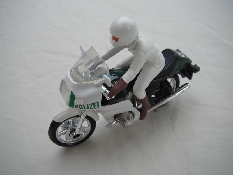 11. Green &amp; white MC/clear windshield/no saddle bags/driver in white/brown boots &amp; gloves/white helmet/no visor/Polizei.