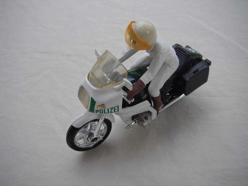 10. Green &amp; white MC/lt.amber windshield/blk saddle bags/driver in white/brown boots &amp; gloves/white helmet/amber visor/Polizei.