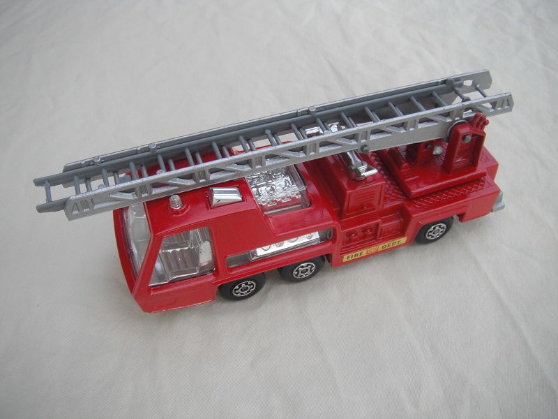 9.  Red body/silver base/dk.red ladder platform/clear windows/gray ladder insert/Fire Dept labels.