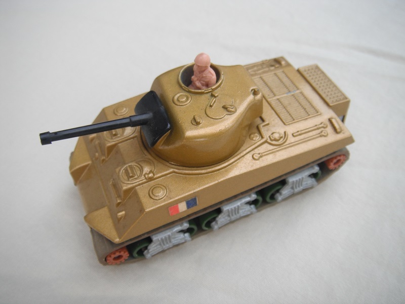 8. Dk.gold body/silver base/green rollers/dk.brown cog with gears/brown tracks/French flag label/pinkish-tan driver.