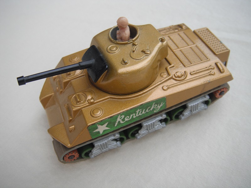 5. Dark gold body/silver base/green rollers/brown cog with gears/gray tracks/green Kentucky label/tan driver.