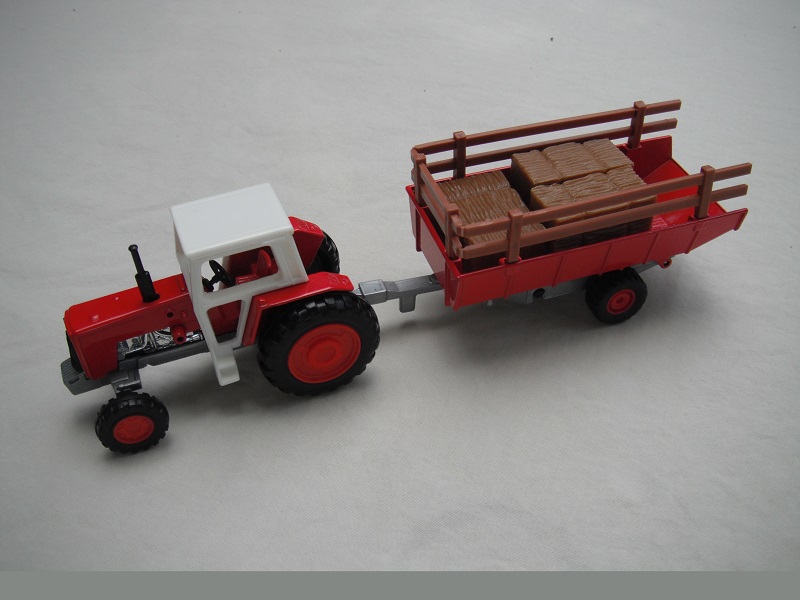 8. Dk.red body/wht canopy/sil China base/closed/BPT/red hubs/blk steering/dk.red trlr/lt.brn stakes/sil base #1/BPT/red hubs/sil tow eye/holes in tractor casting.