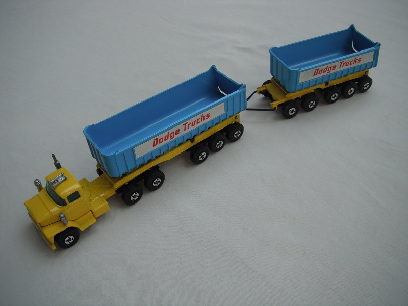 12.Dk.yellow cab &amp; base/lt.blu tipper/black front &amp; rear axle covers/type c tailgate/dk.grn wind/Trailer w/black axle covers/&quot;Dodge Trucks&quot; in red.