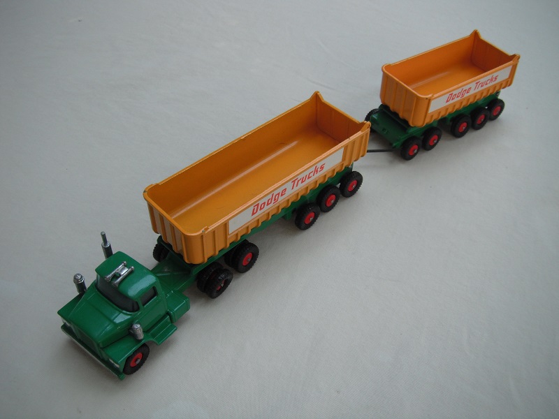 8.Dk.green cab/type 4 base/blue tint axle holder/dk.yel tipper/type 3 underside/type b tailgate area/&quot;Dodge Trucks&quot; in red letters.