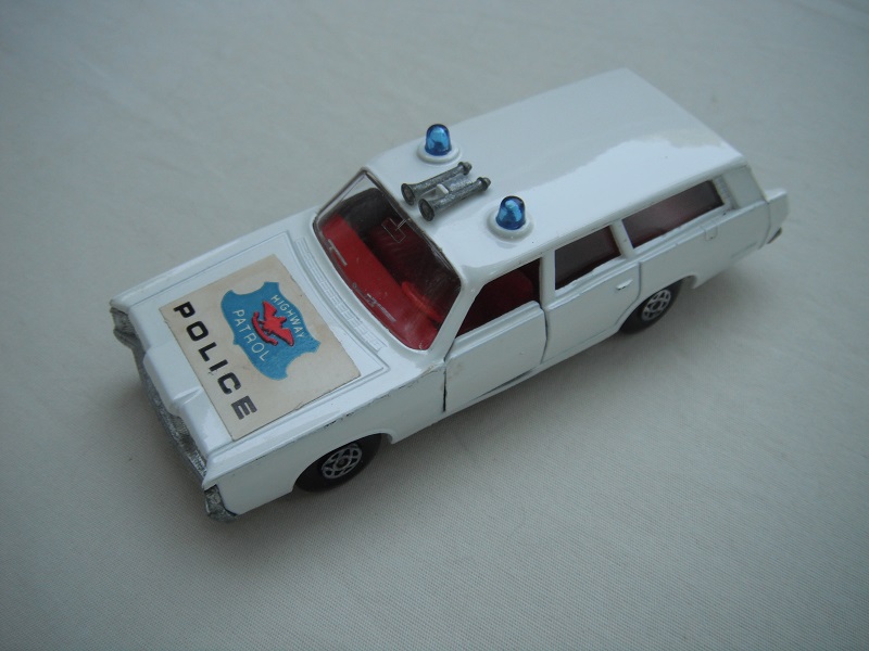 7. Off white body/silver base/spiro wheels/clear windows/red interior/blue Police labels on hood.