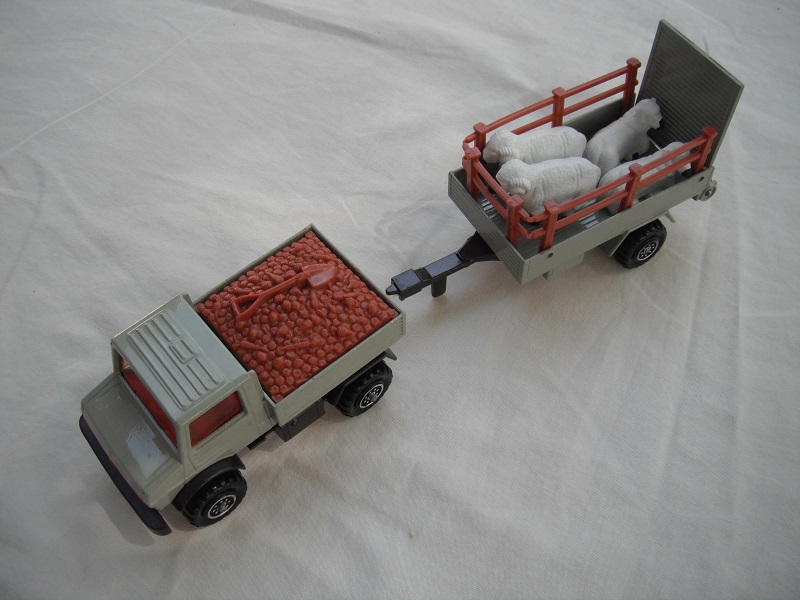 4. Gray body/dk.red grill/brown insert/dk.brn base/8 dot ringed whls/lt.amber windows/gray trailer/dk.brn base #2/farm animals.