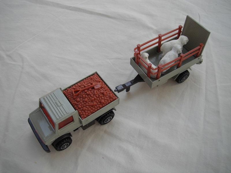 3. Gray body/red grill/brown insert/dk.brn base/8 dot ringed whls/lt.amber windows/gray trailer/dk.brn base #2/farm animals.