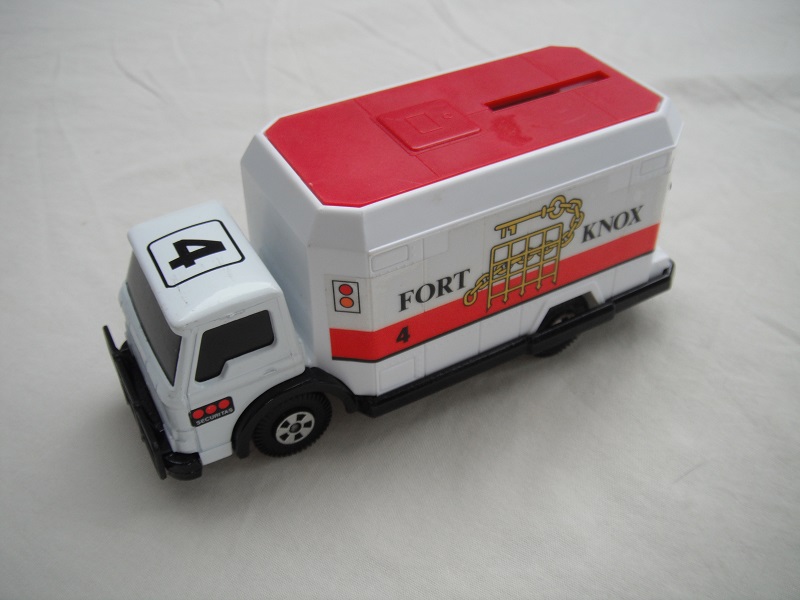 9. White cab/white container/red roof/blk base/Matchbox Macau/5 spk whls/red axle covers/blk windows no mesh/Fort Knox.