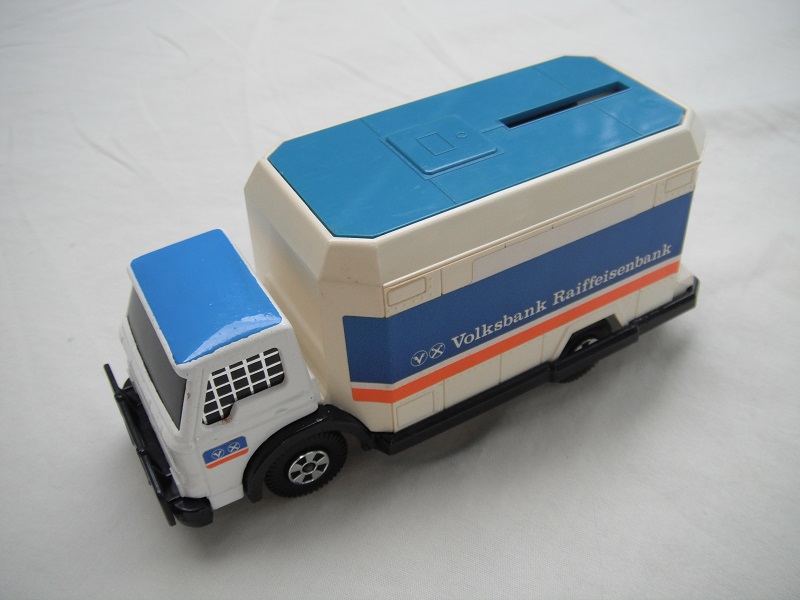 2. Off white cab/cream container/blue roof/blk base/Lesney England/5 spk whls/blu axle covers/blk windows w/mesh/Volksbank.