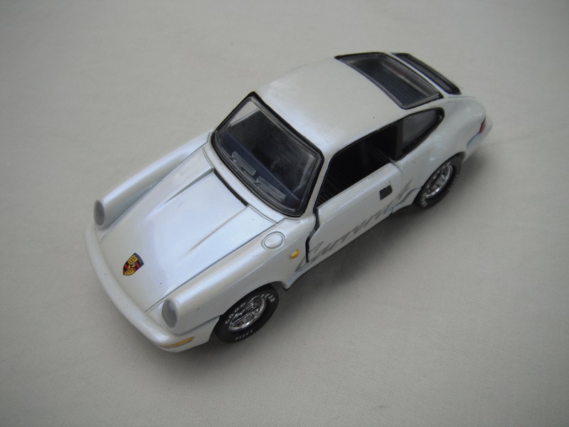 6. Pearly white body/detailed gloss blk China base/5 hole deep dish whls/clr windows/very dk.blue interior/yel side lts/Carrera 4.