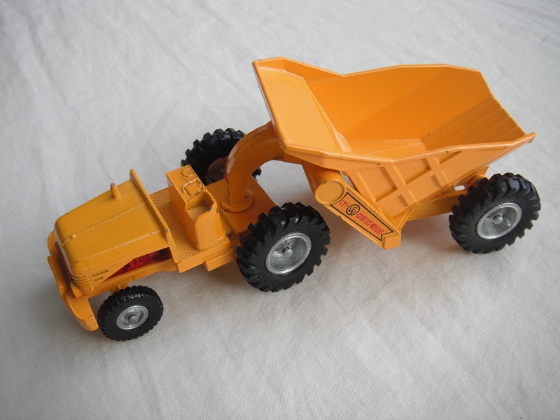 2. Dark yellow body/Silver metal with black plastic tires/Curtiss Wright decals on dumper's arms.