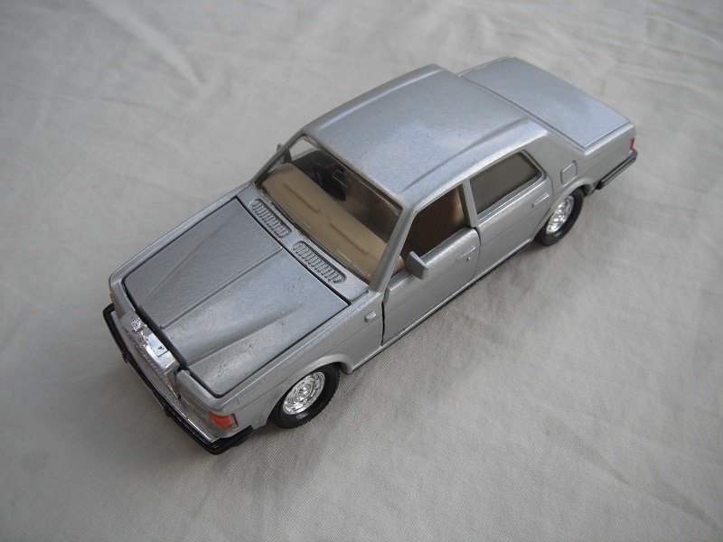 2. Metallic silver body/black Macau base/dish whls/clear windows/dark cream int/orange side lights.