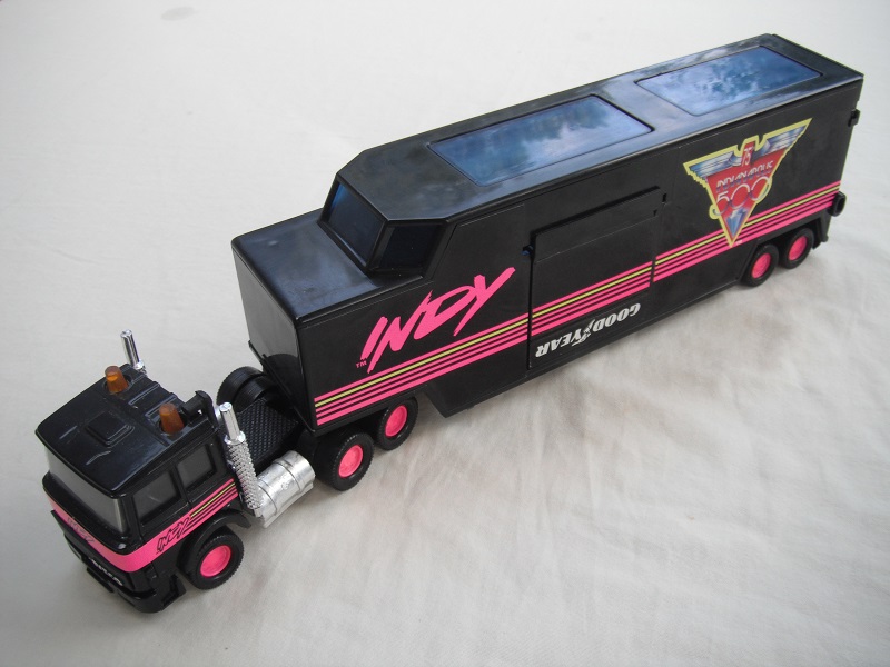 7. Black cab/blk China base/pink 8 dot disc whls/clr wind/blk int/blk trailer/gray base/no country of origin/76th Indy 500.