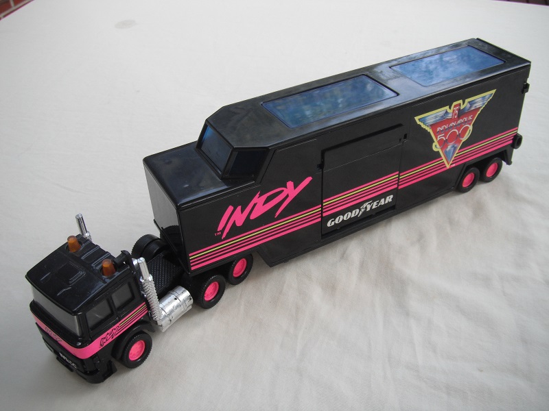 6. Black cab/blk China base/pink 8 dot disc whls/clr wind/blk int/blk trailer/gray base/75th Indy 500/upside down Goodyear.