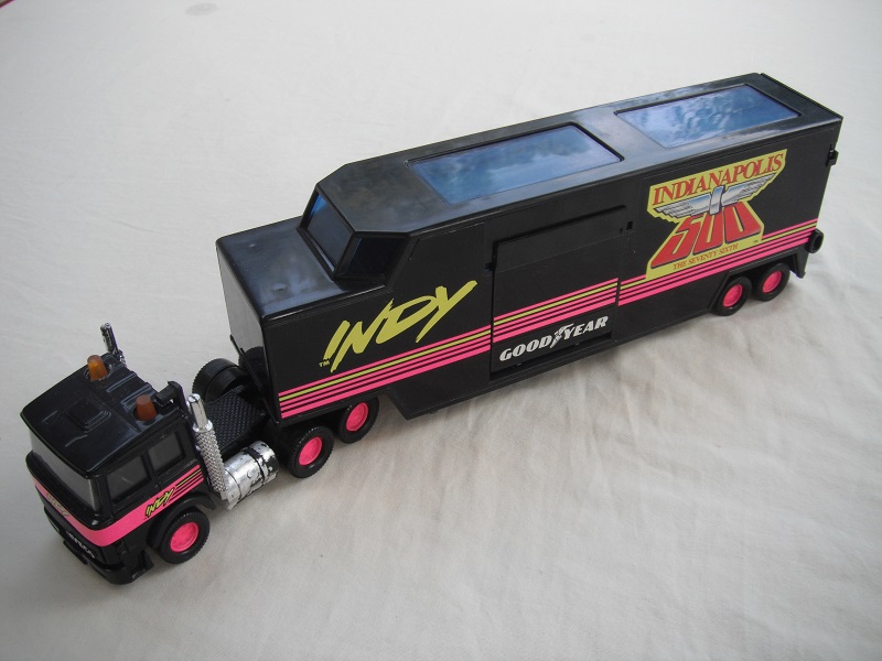 5. Black cab/blk China base/pink 8 dot disc whls/clr wind/blk int/blk trailer/gray base/no country of origin/75th Indy 500.