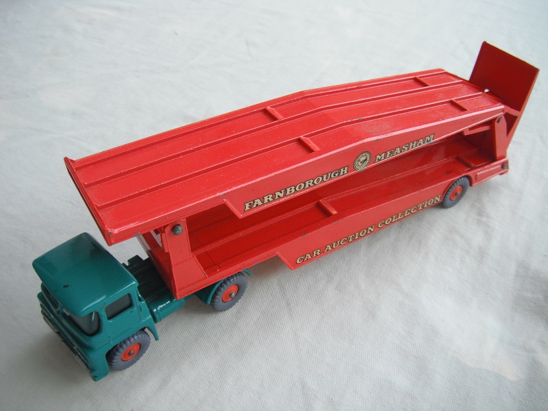 2. Turquoise cab/type 2/blk King Size base/dk.org trailer/Major Pack base/type a/GPT w/org hubs/red axle spring/one ridge rear of ramp/white letters on decals.