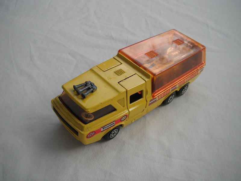 9. Yellow body/orange canopy/dk.red tailgate/sil base/MC whls/amber windows/blk int/blk lts/Team Matchbox/yellow MB34A.