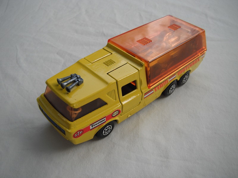 8. Yellow body/orange canopy/dk.red tailgate/sil base/MC whls/amber windows/blue int/blue lts/Team Matchbox/yellow MB34A.