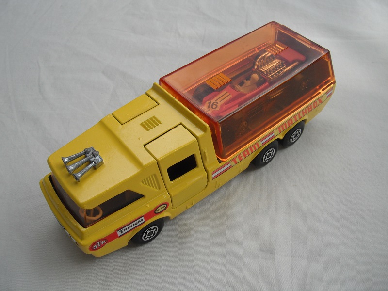 7. Dk.yellow body/orange canopy/dk.red tailgate/sil base/MC whls/amber windows/blk int/chrm lts/Team Matchbox/purple MB34A.