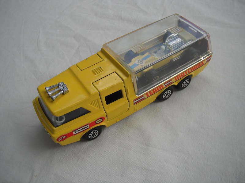 3. Dk.yellow body/clear canopy/dk.red tailgate/sil base/MC whls/clr windows/blk int/chrm lts/Team Matchbox/yellow MB34A.