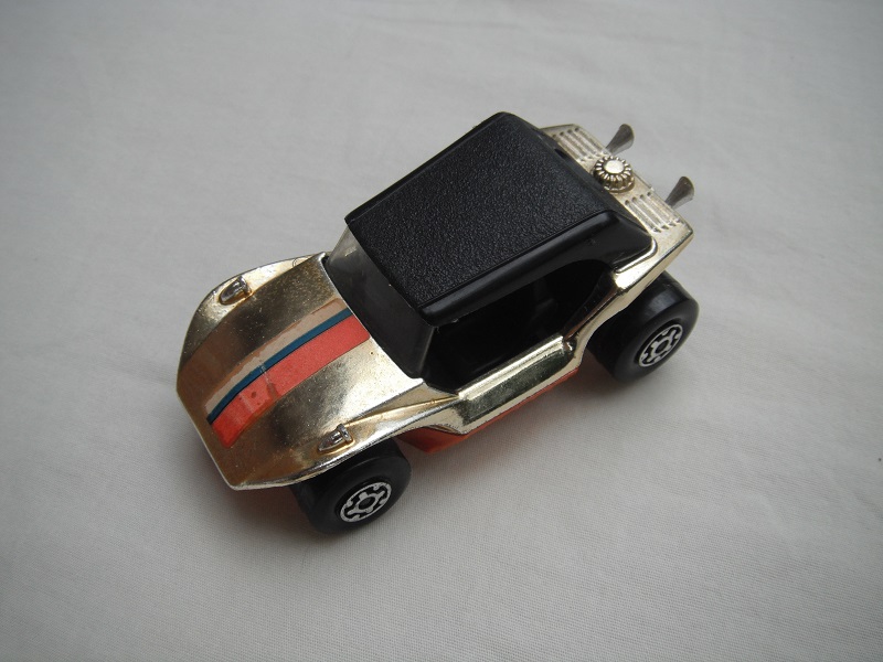 13.Gold plated body/blk roof/orange base/MC wheels/clear windshield/blk int/stripes label/mounted on ashtray.