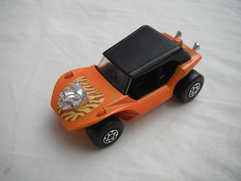 7. Lt.orange body/grn splatter//blk roof/lt.org base/MC whls/clr windshield/blk intr/brown stripes &amp; hood ornament.