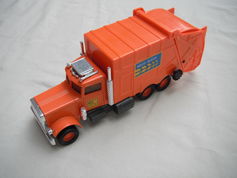 3. Orange body/dark gray Matchbox base/orange 8 dot disc wheels/frosted windows/silver AC unit/Waste Beaters.