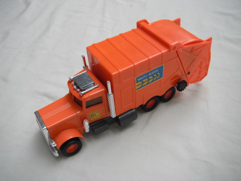 2. Orange body/dark gray Matchbox base/orange 8 dot disc wheels/clear windows/silver AC unit/Waste Beaters.