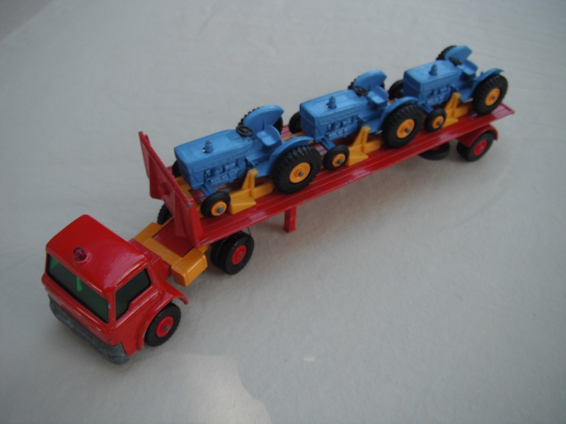 10.Red cab/yel tanks/grn windows/reg whls/dk grnish xle cvr/red trailer/yel rack/wht xle spring/lt. blu tractors/with Pat No.