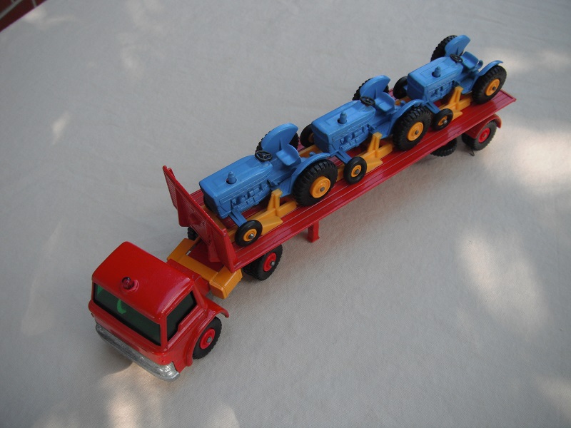 9. Red cab/yel tanks/grn windows/reg whls/greenish xle cvr/red trailer/yel rack/wht xle spring/lt. blu tractors/with Pat No.