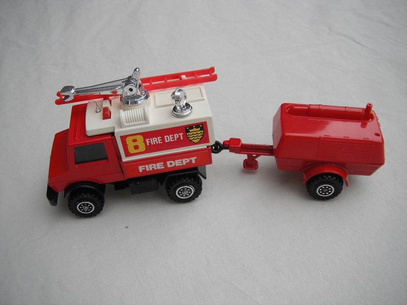 7. Red Unimog/wht canopy/gloss blk base/no hole/Macau/clr wind/blk int/dk.red compr/England/blk tow eye/no hood deco/Fire Dept 8/Fire Dept in white on red background.