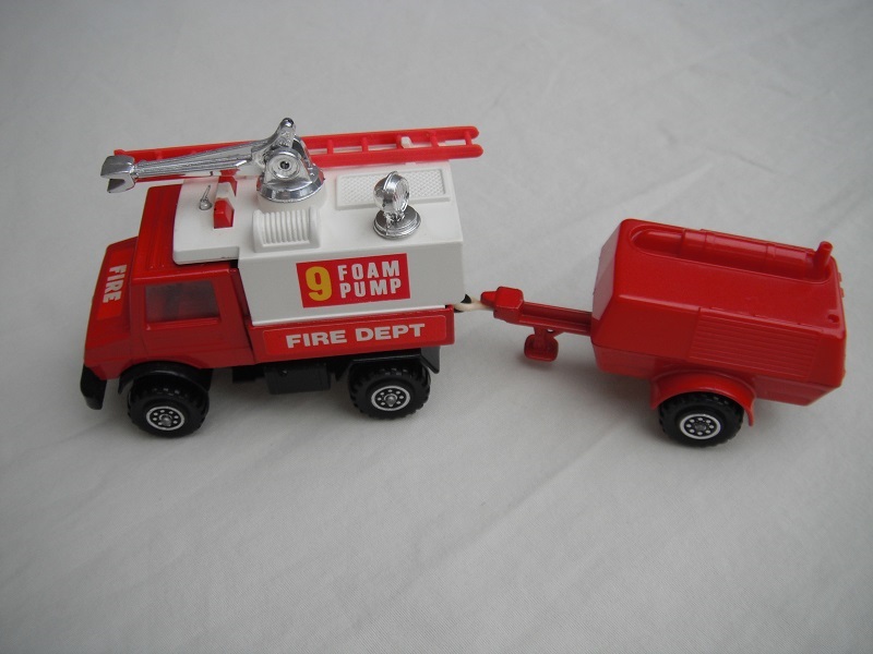 4. Red Unimog/wht canopy/matt blk base/hole/England/clr wind/red int/red compr/England/crm tow eye/Hood lbl typ2/Foam Pump 9/Fire Dept in white on red background.