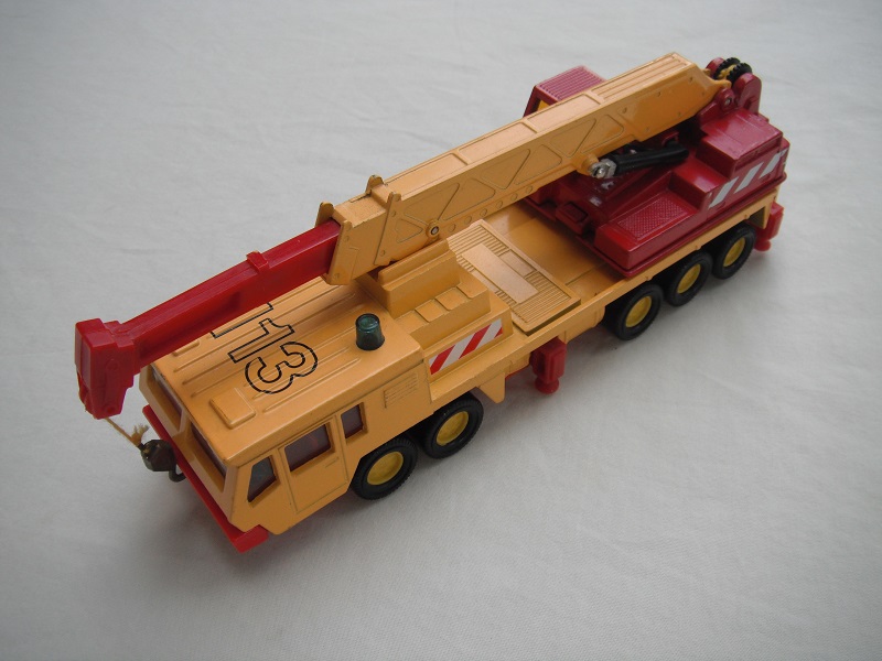 8. Dk.yel body/ribbed roof/red China base/yel 8 dot disc whls/clr wind/red int/dk.red crane cab/amb wind/dk.yel boom/dk.red ext/gld hook/yel cable/113, red &amp; wht stripes.