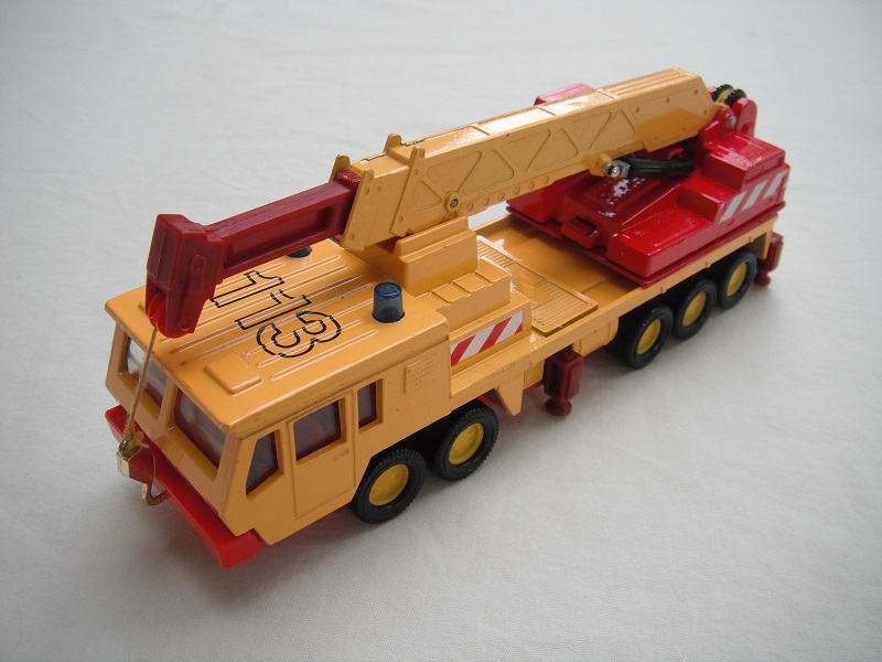 7. Dk.yel body/ribbed roof/red China base/yel 8 dot disc whls/clr wind/red int/red crane cab/amb wind/dk.yel boom/very dark red ext/gld hook/yel cable/113, red &amp; wht stripes.