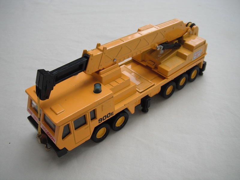 3. Dk.yel body/smooth roof/blk Macau base/yel 8 dot disc whls/clr wind/blk int/dk.yel crane cab/amb wind/dk.yel boom/blk ext/gld hook/yel cable/900E &amp; TW on wht background.