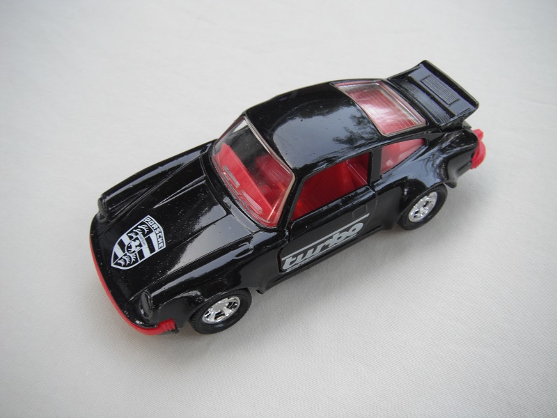 33. Black body/black base/red int/red steering/clear windows/turbo on sides/black &amp; white logo on hood/China cast.