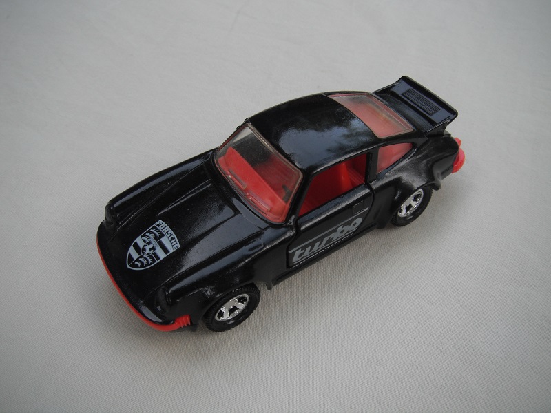 26. Black body/black base/red int/black steering/clear windows/turbo on sides/logo on hood/no roof label/England cast.