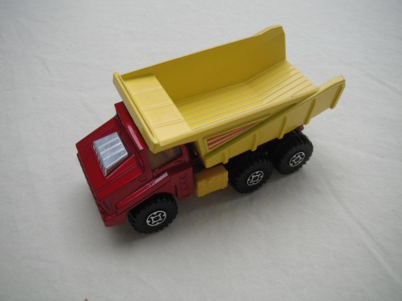 6. Metallic red body/yellow dump type a/silver base type a/dk.yellow press-o-matic/MC wheels/.amber windows/3 stripes labels.