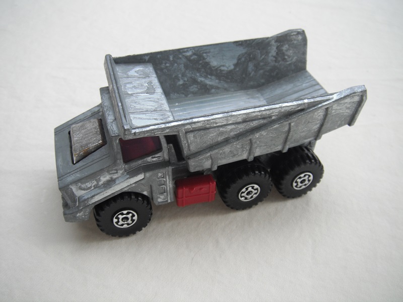 1. Unpainted body/unpainted dump type a/unpainted prepro base/red press-o-matic/MC wheels/purple windows/no labels.