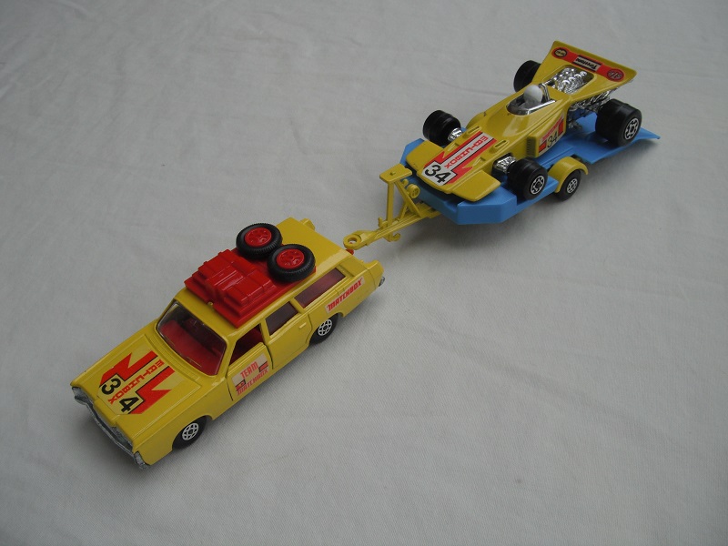 9. Yellow car/unpainted K46 base/spiro whls/clr windows/dk.red int/dk.red roof rack/yel &amp; blue king size tlr/spiro wheels/yellow race car &quot;34&quot;.