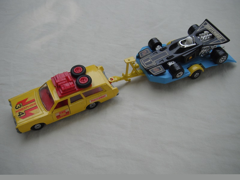 6. Yellow car/unpainted K23 base/spiro whls/clr windows/red int/dk.red roof rack/dk.yel &amp; blue king size tlr/spiro whls/black race car &quot;1&quot;.