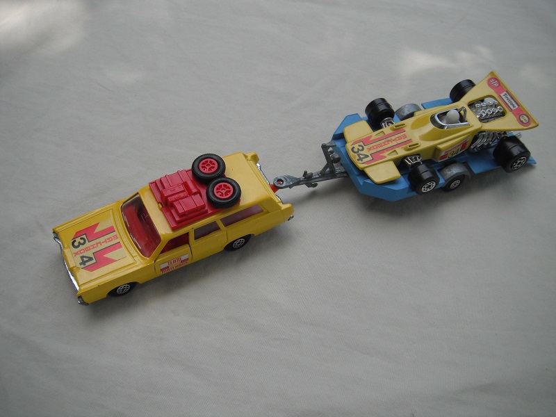 1. Yellow car/unpainted K23 base/spiro whls/clr windows/dk.red int/red roof rack/yel &amp; blue king size tlr/spiro whls/yellow race car &quot;34&quot;.