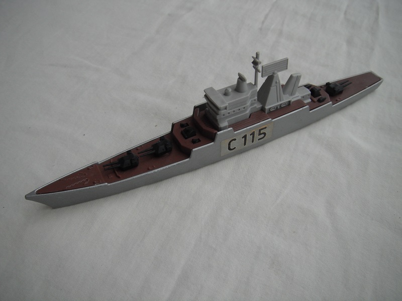 1. Silver/gray hull/dk.brown deck/lt.gray superstructure/K310 Anti-Aircraft Cruiser 1977 base/black turrets &amp; weapons/&quot;C115&quot; labels.