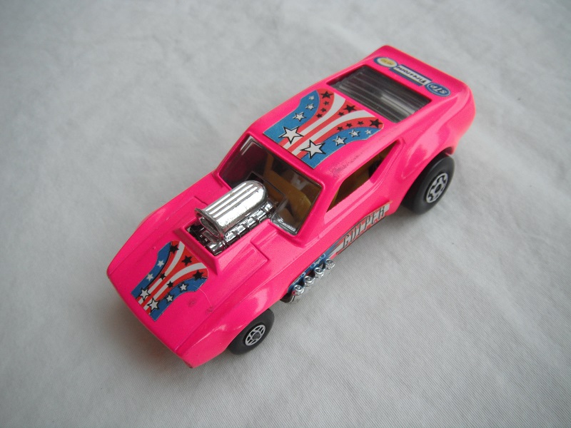 13.Dark pink body/cylinder shaped ES/blk base/spiro &amp; MC whls/clr windows/yellow interior/yellow cage//Gulper,stars &amp; stripes/blu lbls.