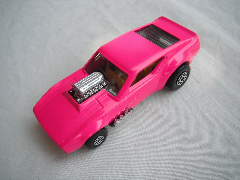 6. Dark pink body/cylinder shaped ES/blk base/spiro &amp; MC whls/clear windows/yellow interior/yellow cage/no labels.