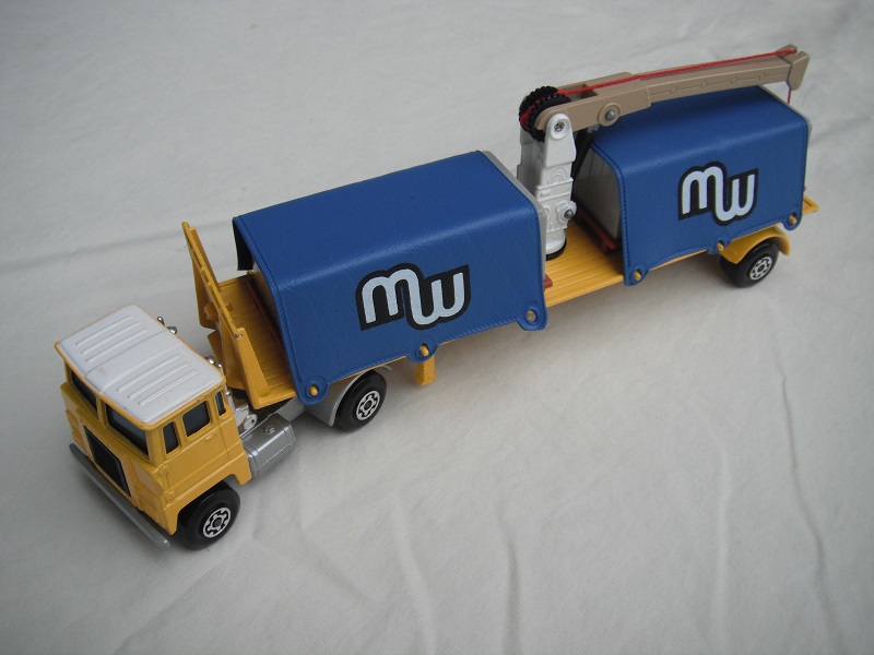 10.Yel &amp; wht cab/sil base/blk grill/SM/blu wind/blk int/MC whl/blk xle cvr fwd/dk.yel trailer/wht ctr post/tan boom/MC whl/blk xle cvr/red cbl/gld hk/blu tarp/gry cont/brn pallets/&quot;MW&quot; in wht.