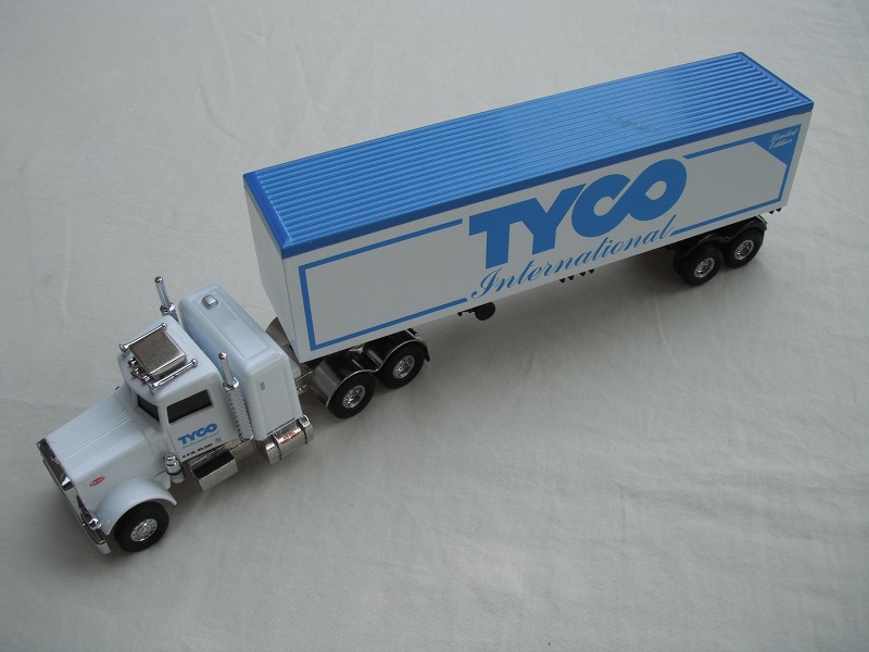 4. White cab/chrome chassis/black rubber tires/white container with blue roof/&quot;Tyco International&quot; tempa.