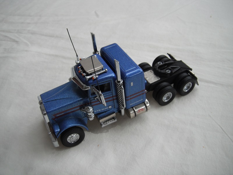 1. Metallic blue cab/black chassis/black rubber tires/two red stripes tempa.